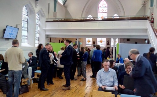 A renovated chapel at DIT filled with people standing and chatting
