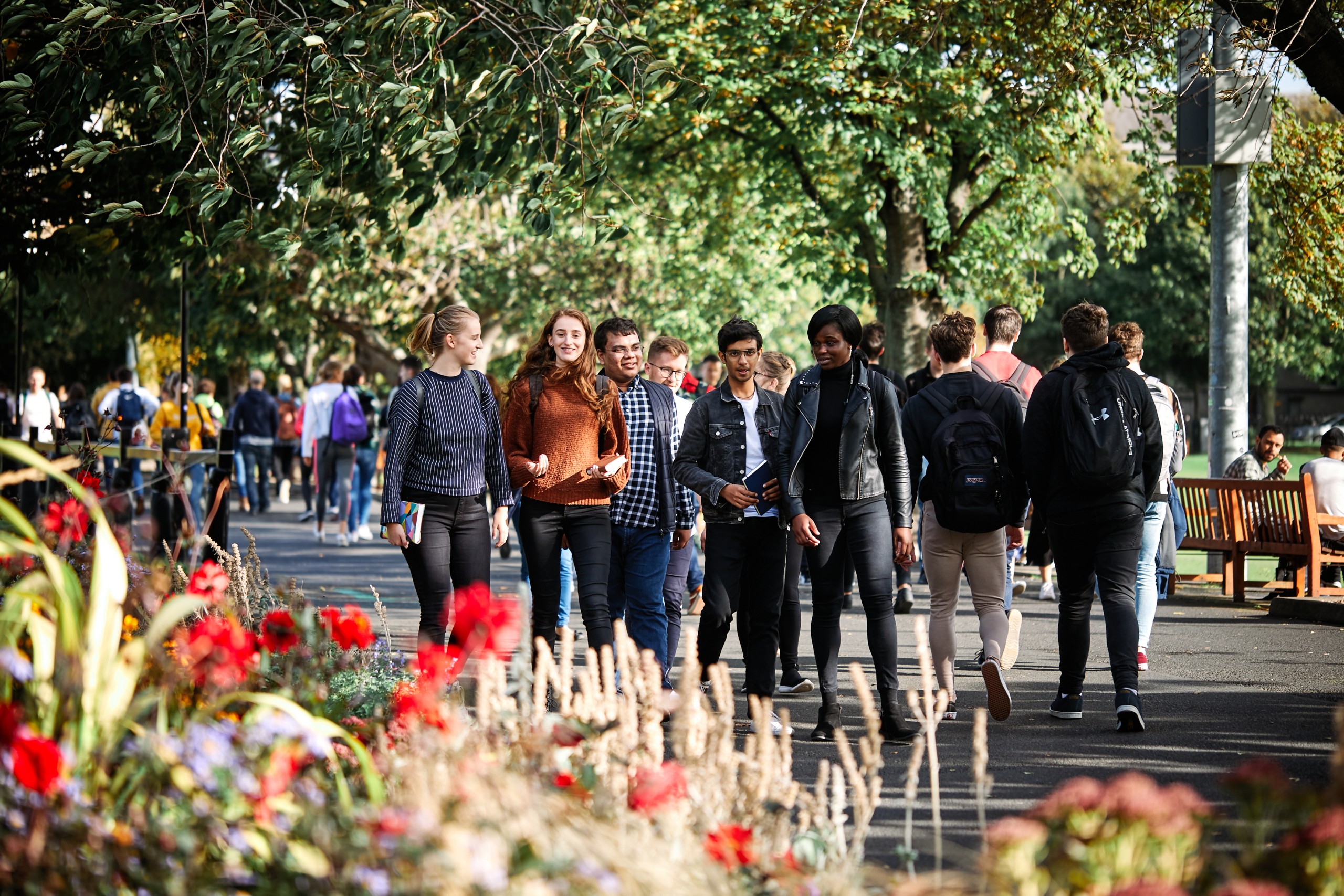 A group of students walk together on campus