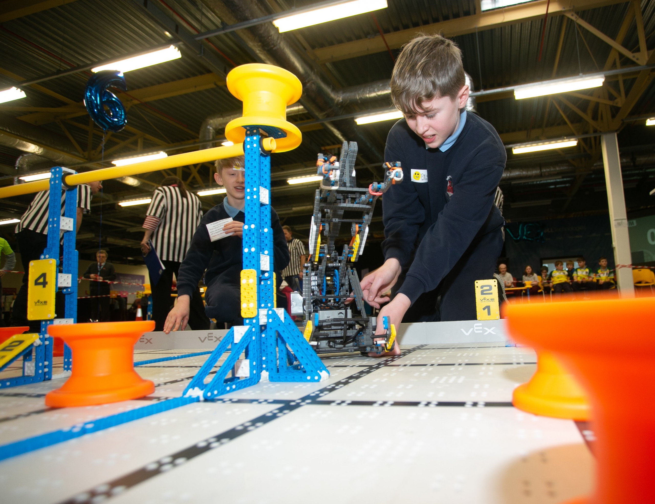 Two students handle their LEGO creation at the Vex Robotics Competition