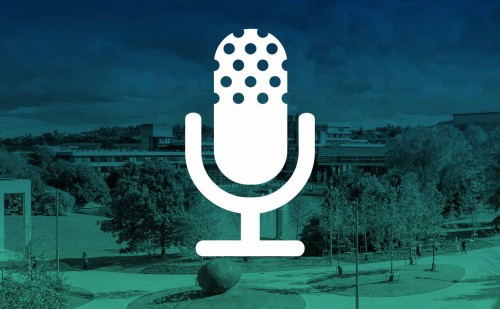 A white mic icon on top of an image of a college campus