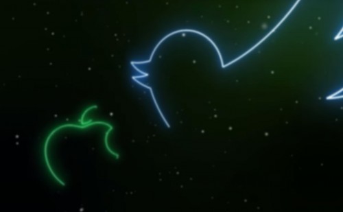 Two glowing lines trace the outline of the twitter logo and the apple mac logo on a dark background