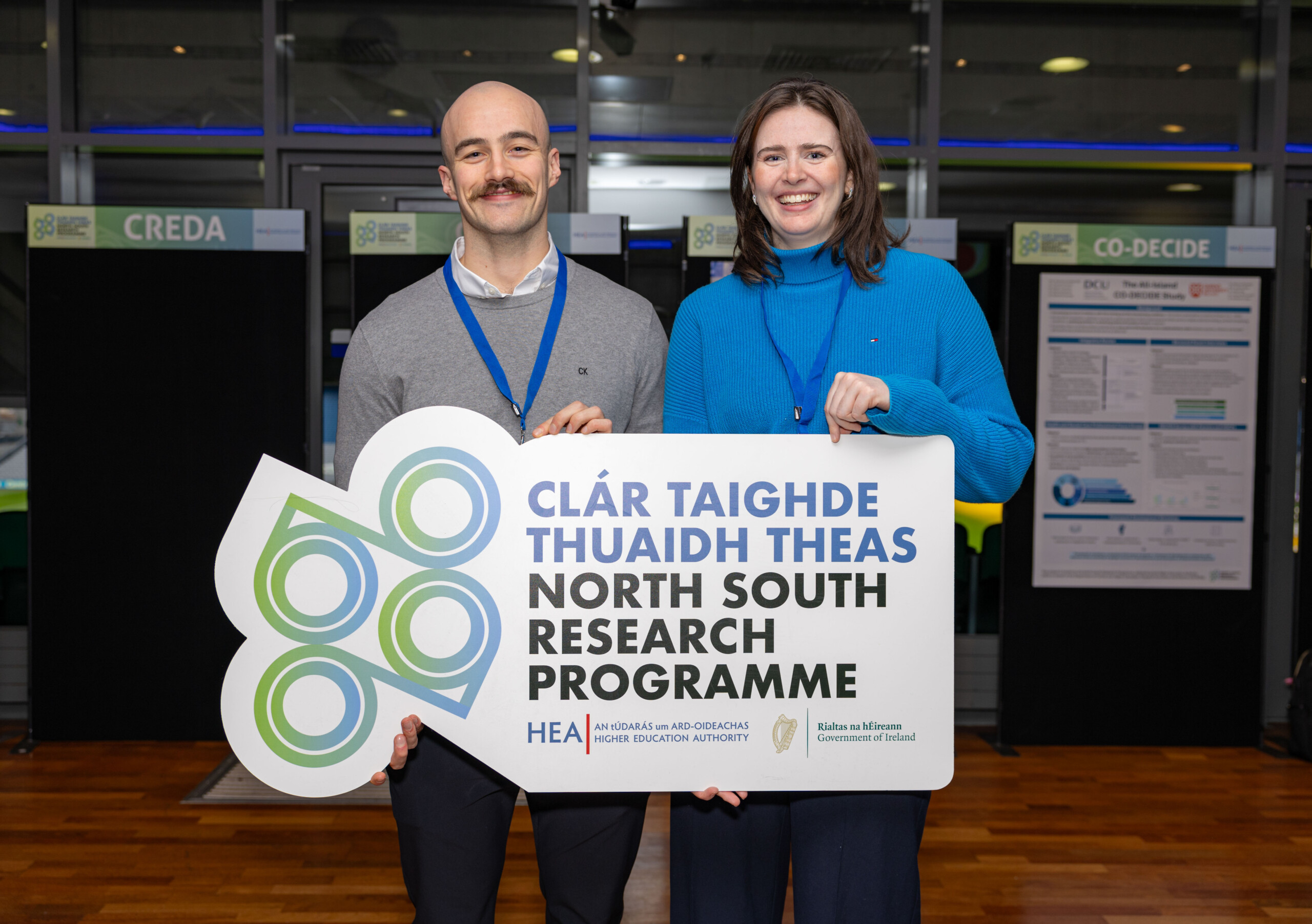 Two conference participants posing with NSRP banner