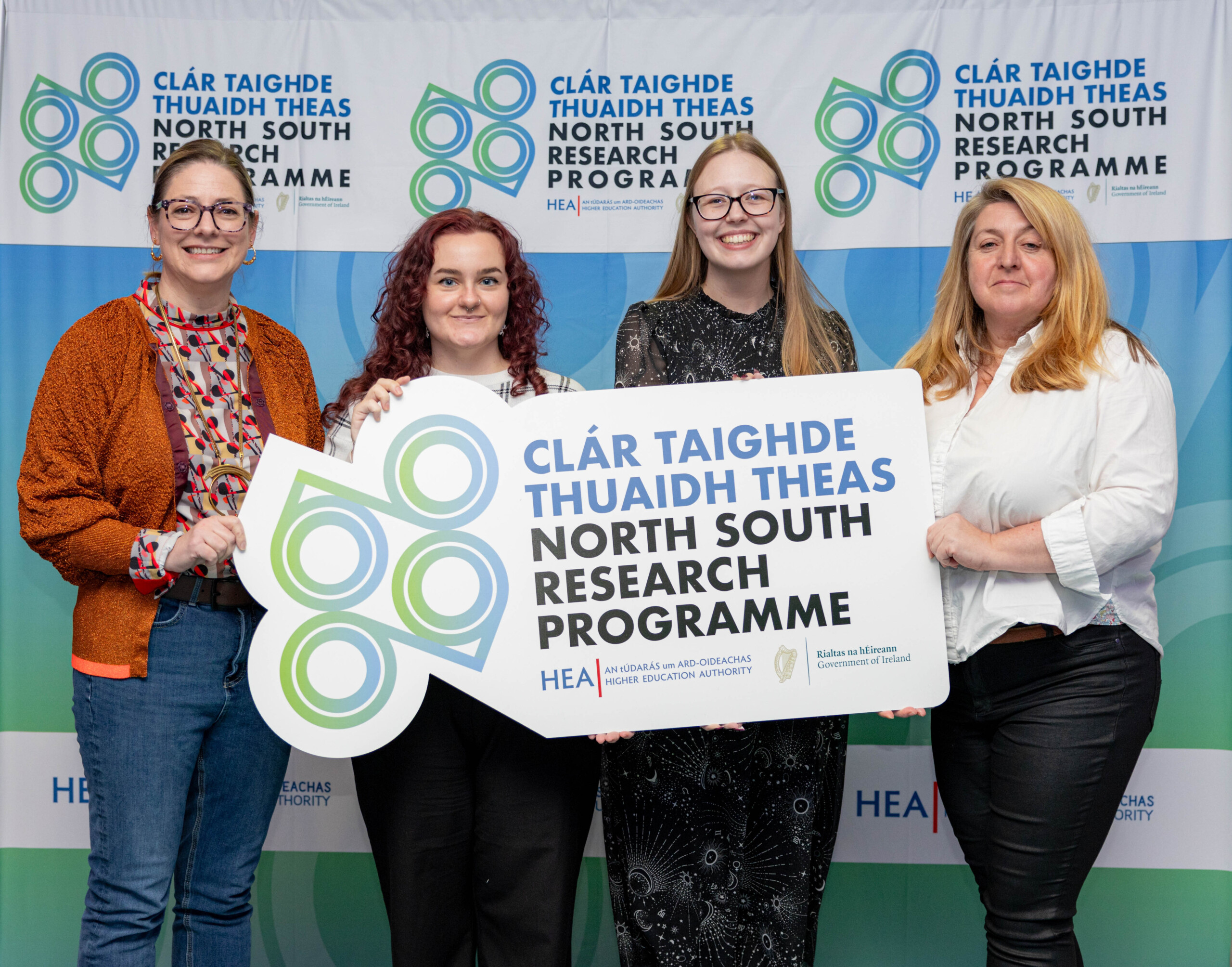 Four researchers holding NSRP banner