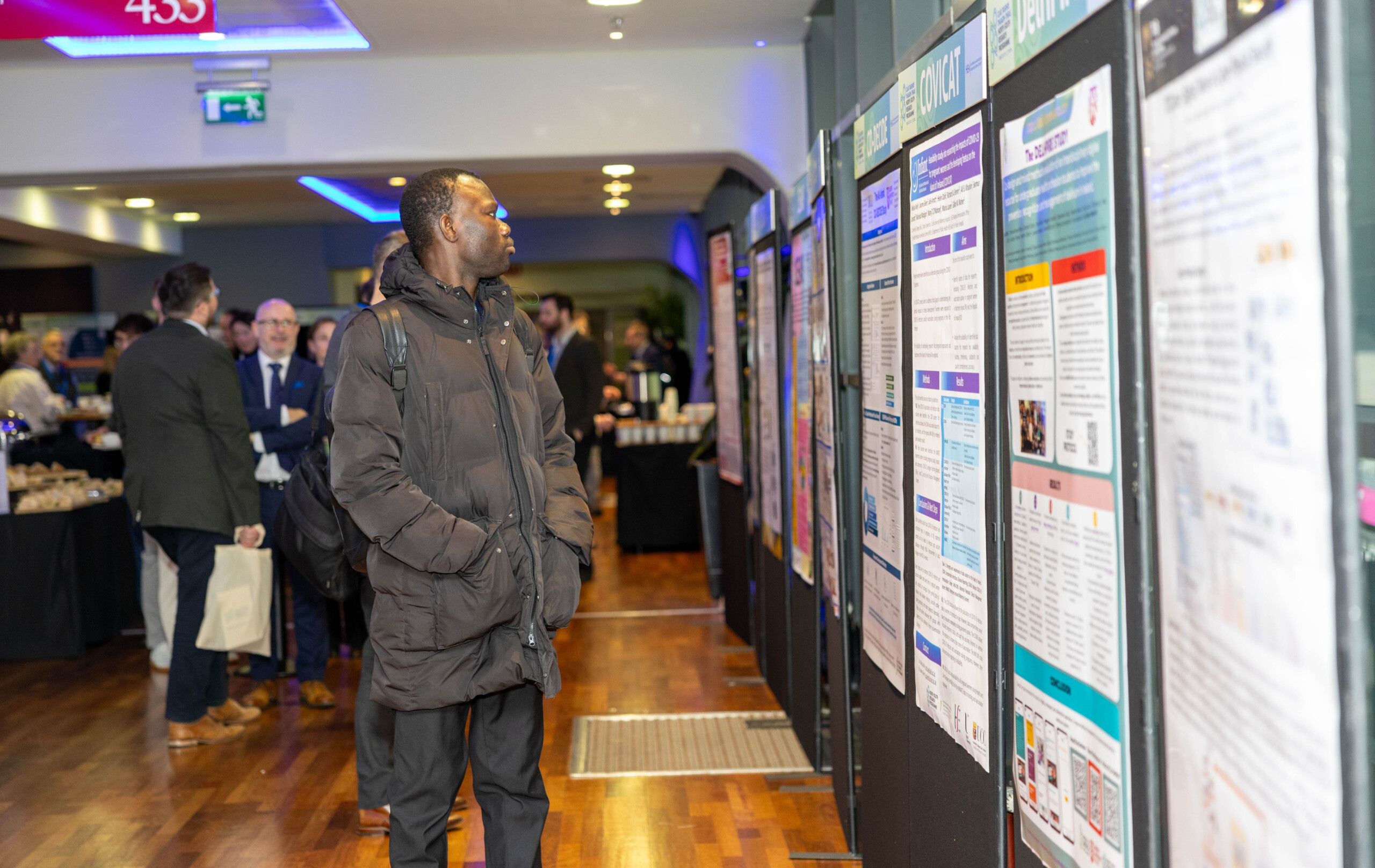 Image of an attendant looking at information boards at the North South Research Conference 2024 in Croke Park, Dublin.