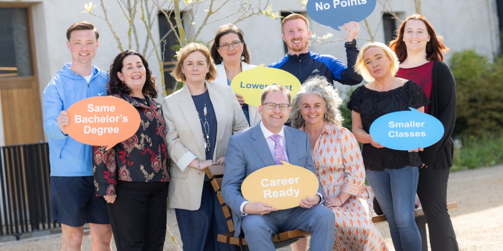 Minister Lawless and a group of others holding up banners at launch of new tertiary degree courses for the 2025/2026 academic year
