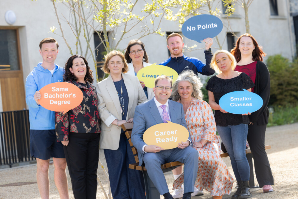 Minister Lawless and a group of others holding up banners at launch of new tertiary degree courses for the 2025/2026 academic year