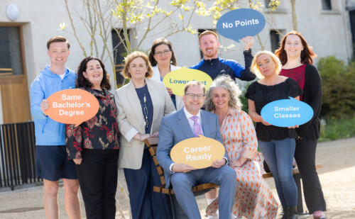 Minister Lawless and a group of others holding up banners at launch of new tertiary degree courses for the 2025/2026 academic year