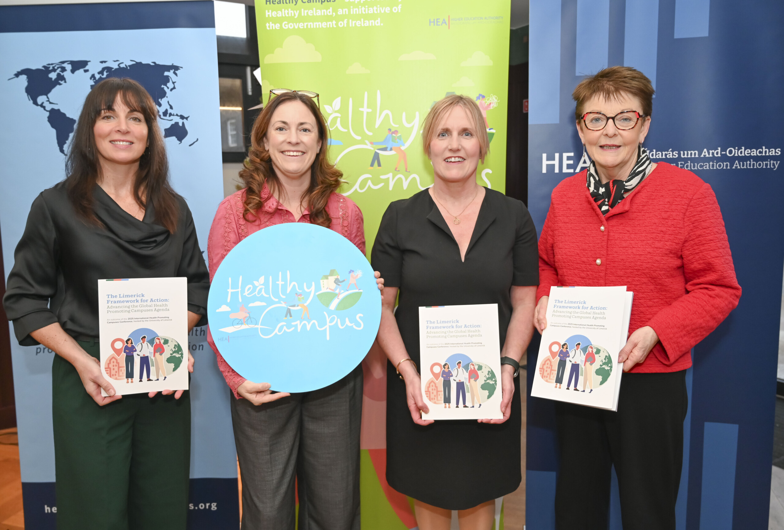 Group of four women holding copies of the Limerick Framework for Action booklet