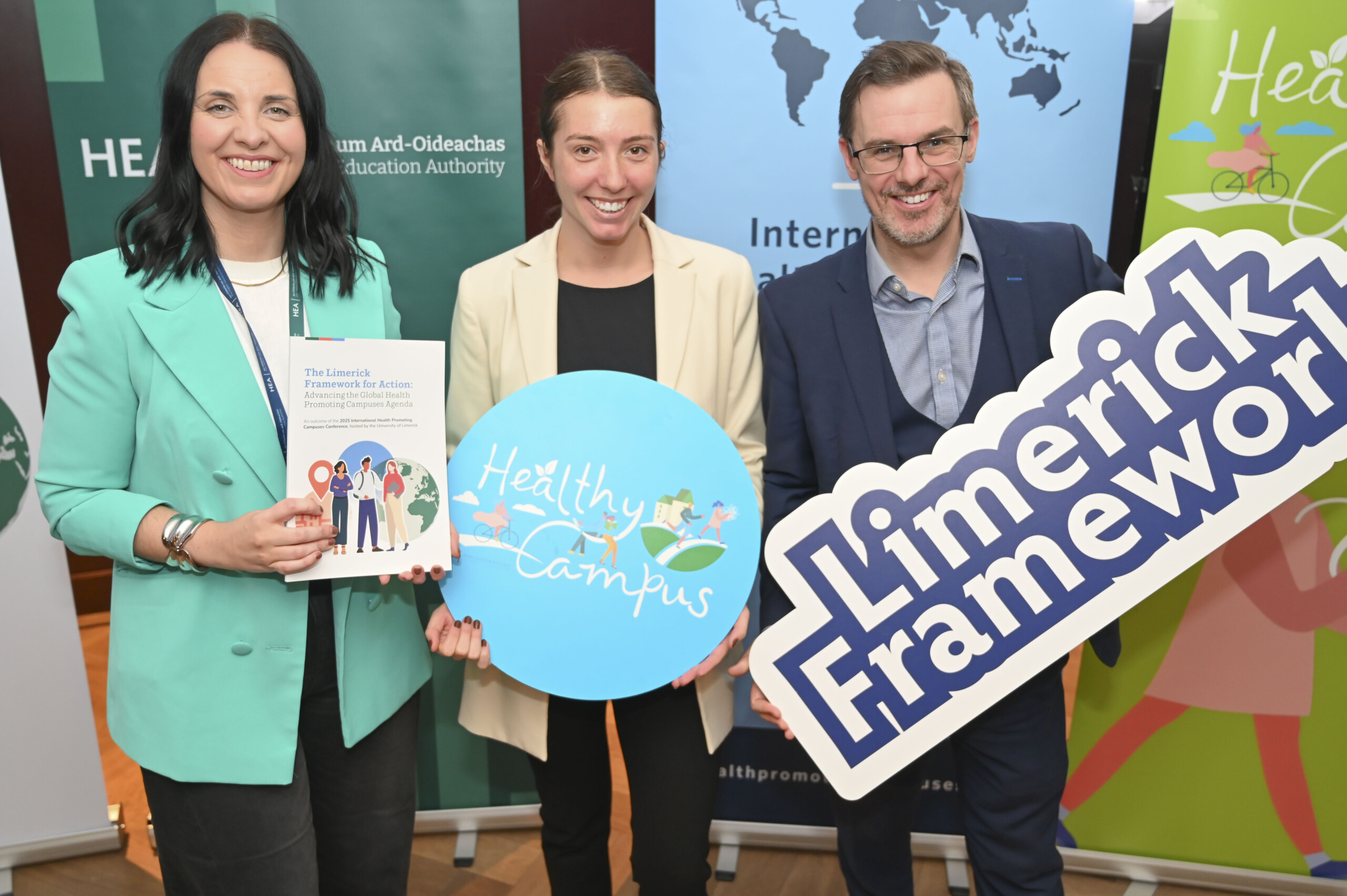 Group of people holding up banners at the Launch of the Limerick Framework for Action