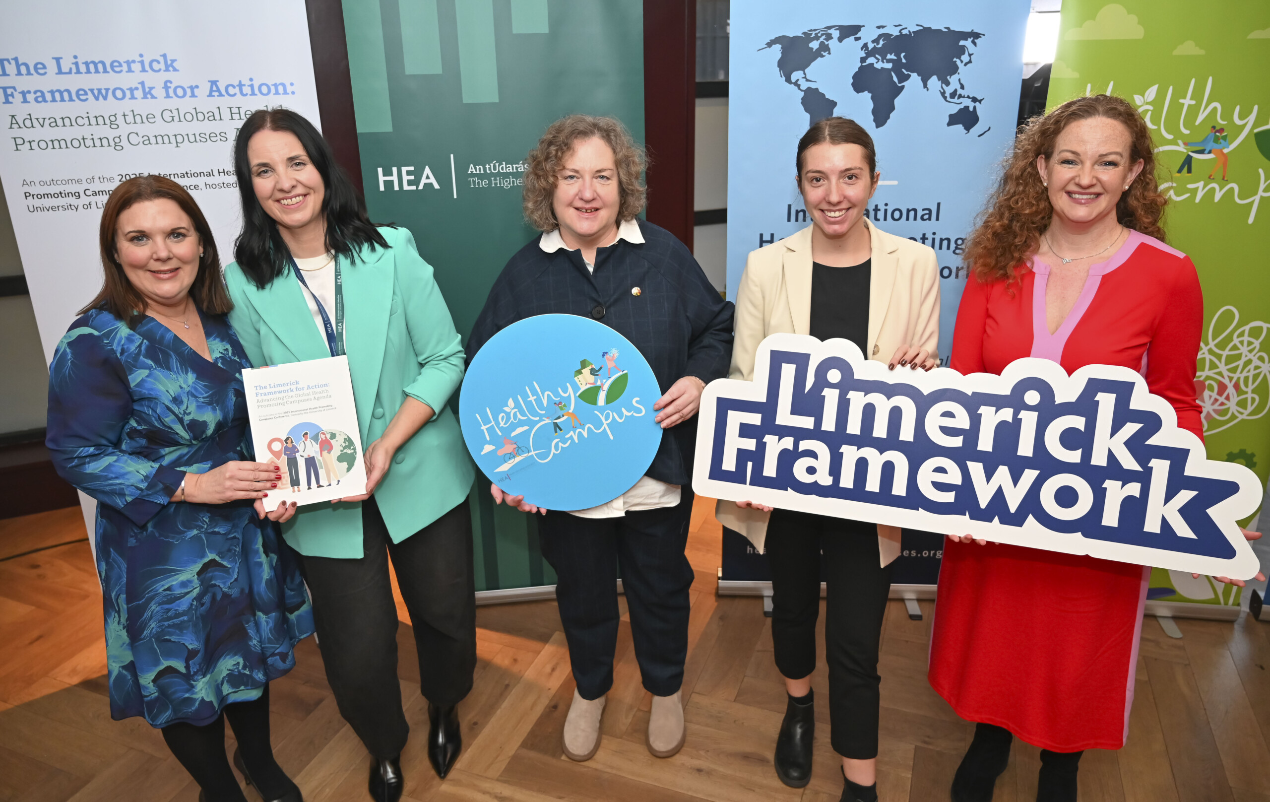 Group of people holding up banners at the Launch of the Limerick Framework for Action