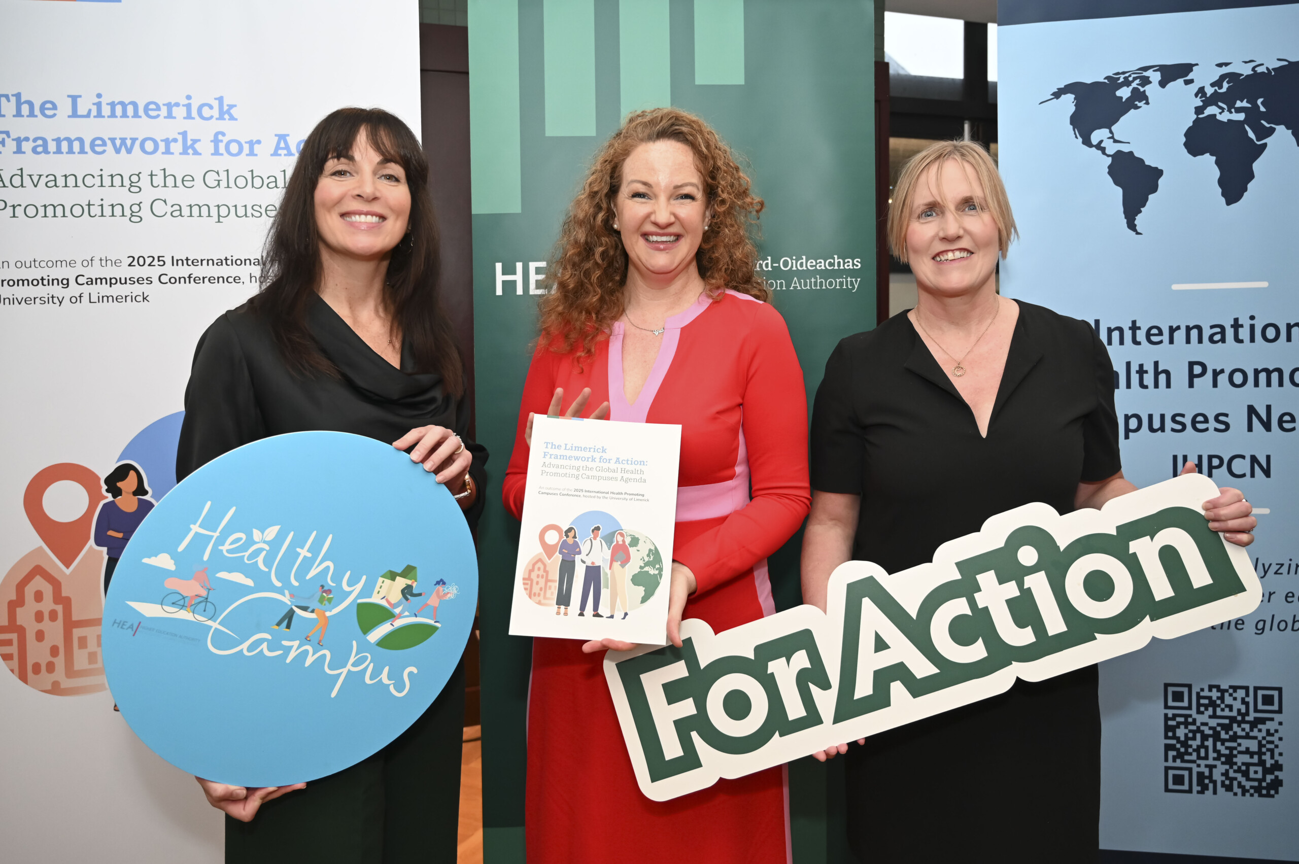 Group of people holding up banners at the Launch of the Limerick Framework for Action