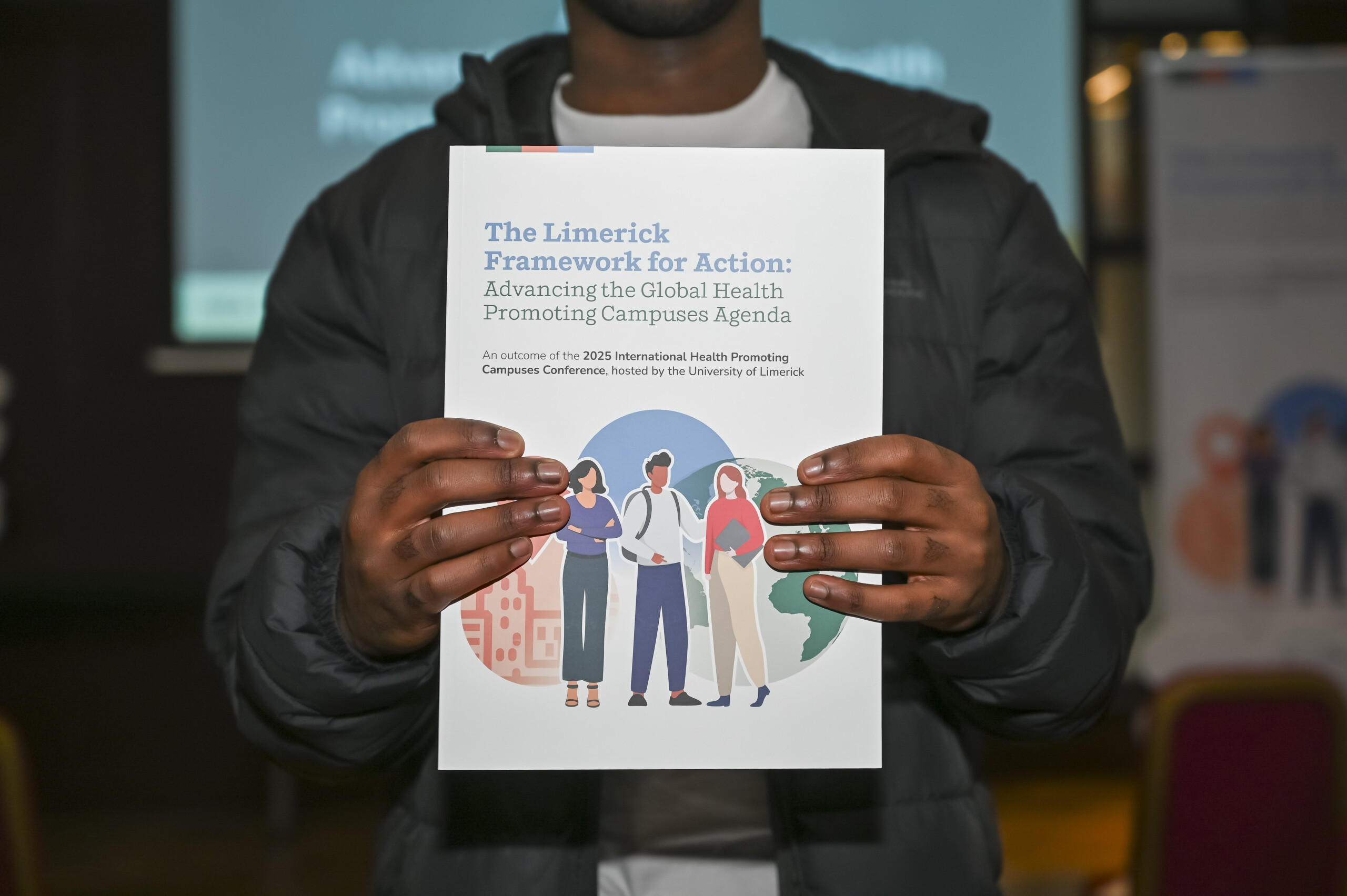 Man holding up copy of the Limerick Framework for Action booklet