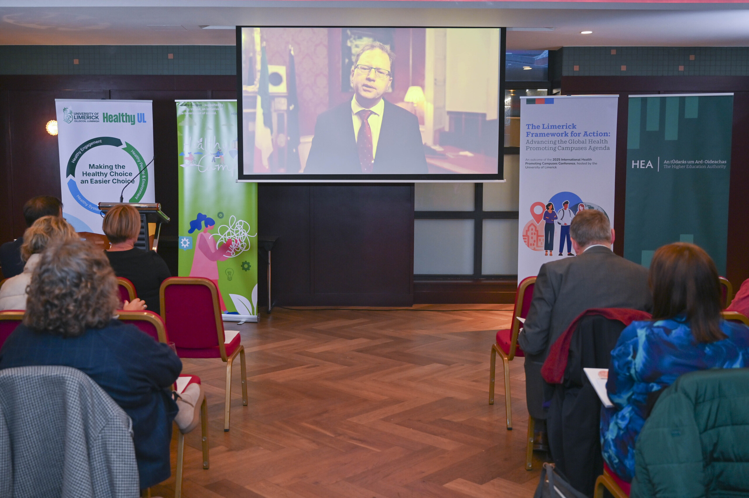 Group of people looking at a presentation at the launch of the Limerick Framework for Action