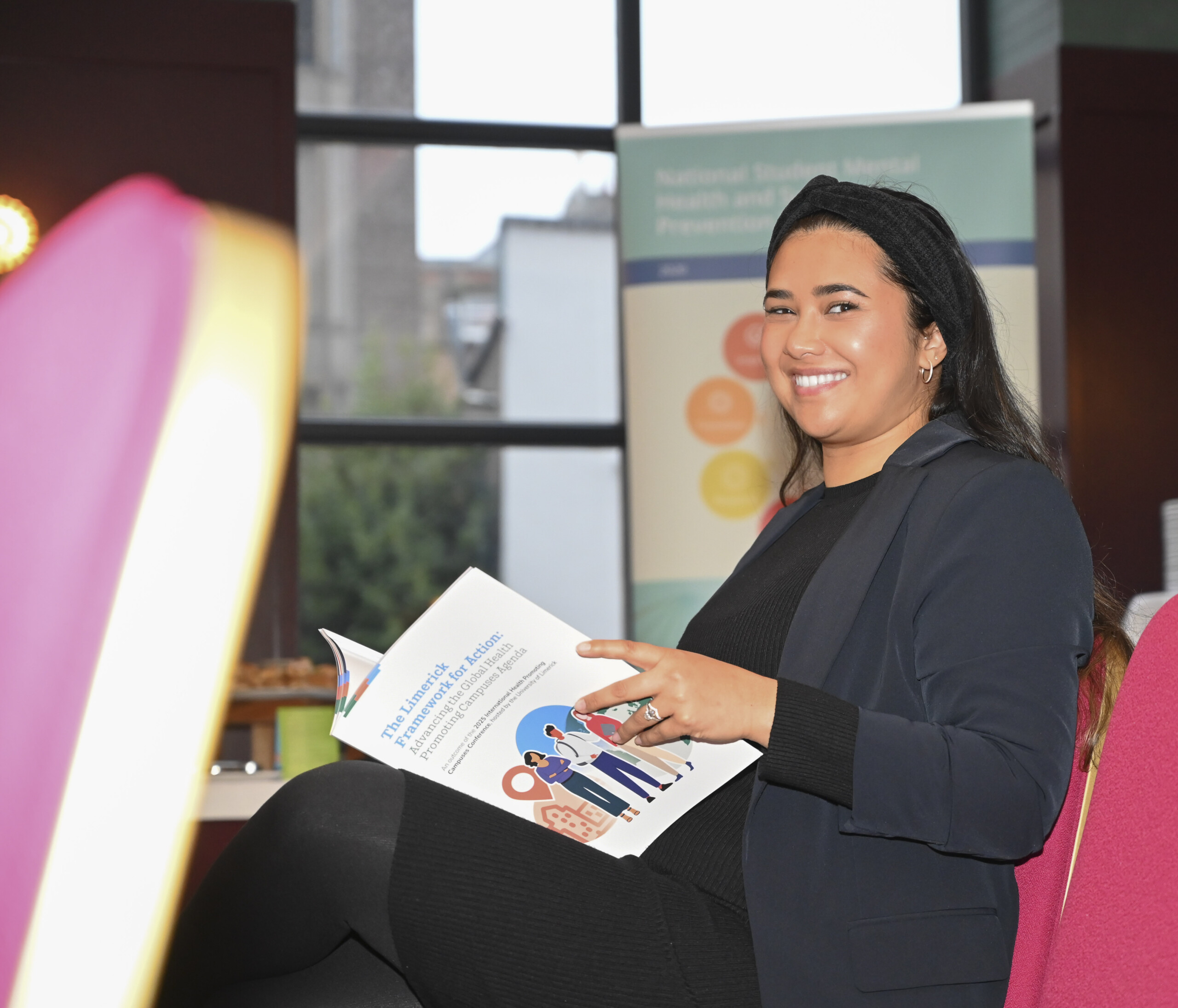 Woman reading copy of the Limerick Framework for Action booklet