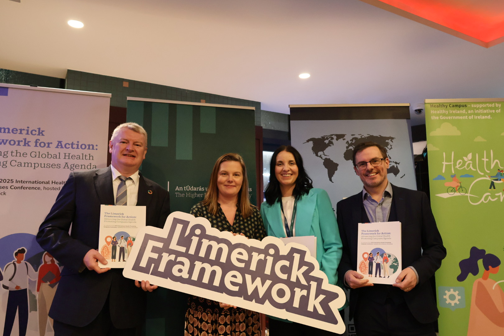 Group of people holding up banners at the Launch of the Limerick Framework for Action