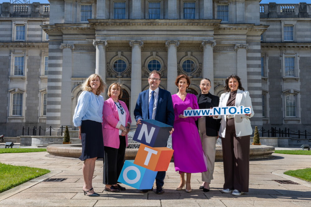 Image of Minister Lawless and Minister Naughton posing with NTO team in front of Government building