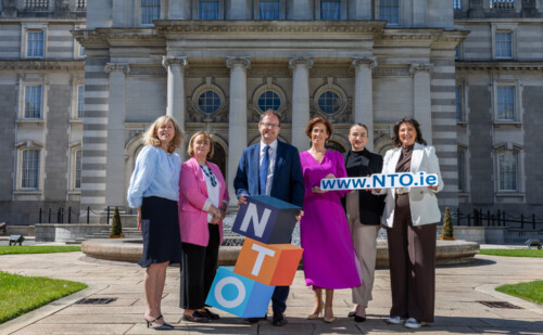 Image of Minister Lawless and Minister Naughton posing with NTO team in front of Government building