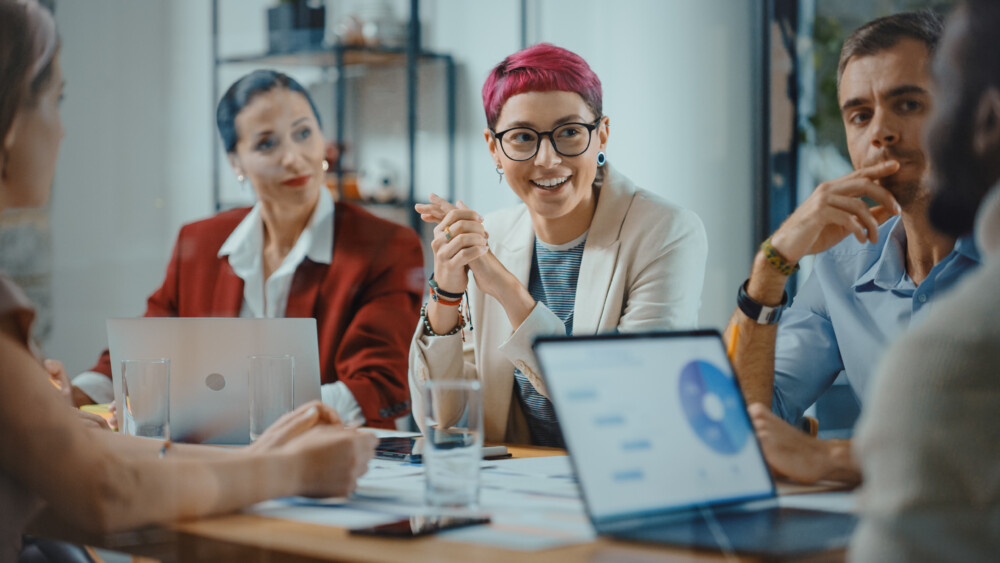 image of three people sitting in a meeting