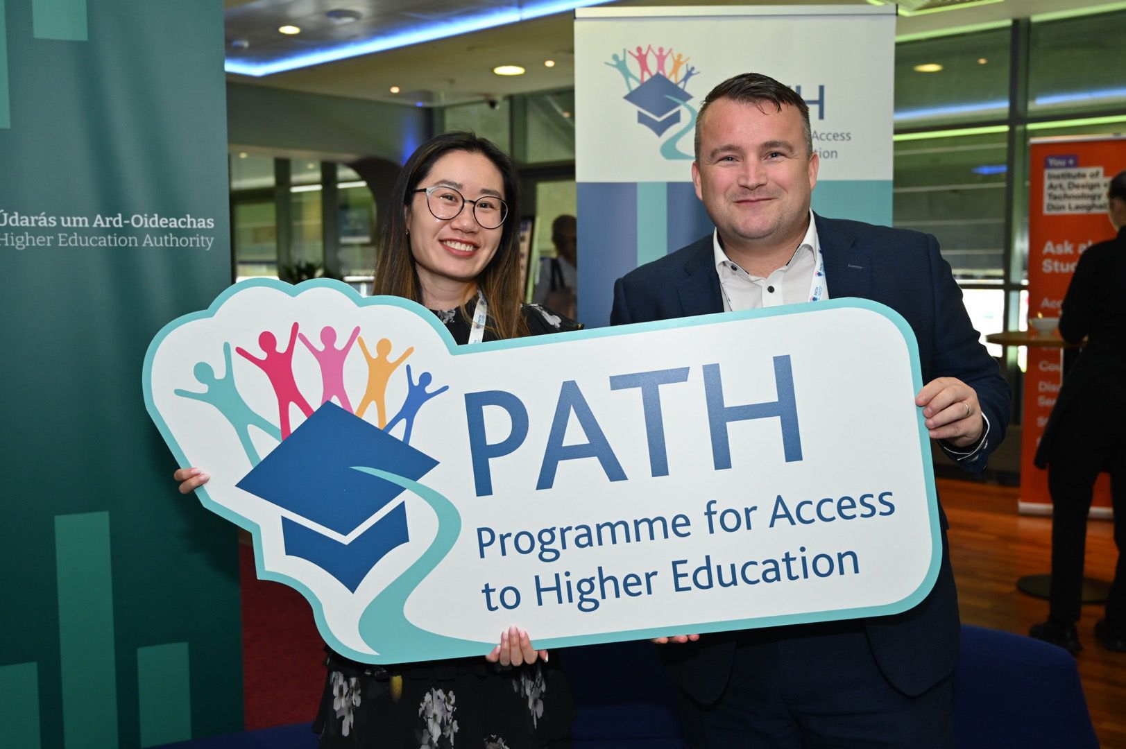 Janice Lau and David Reilly holding PATH banner