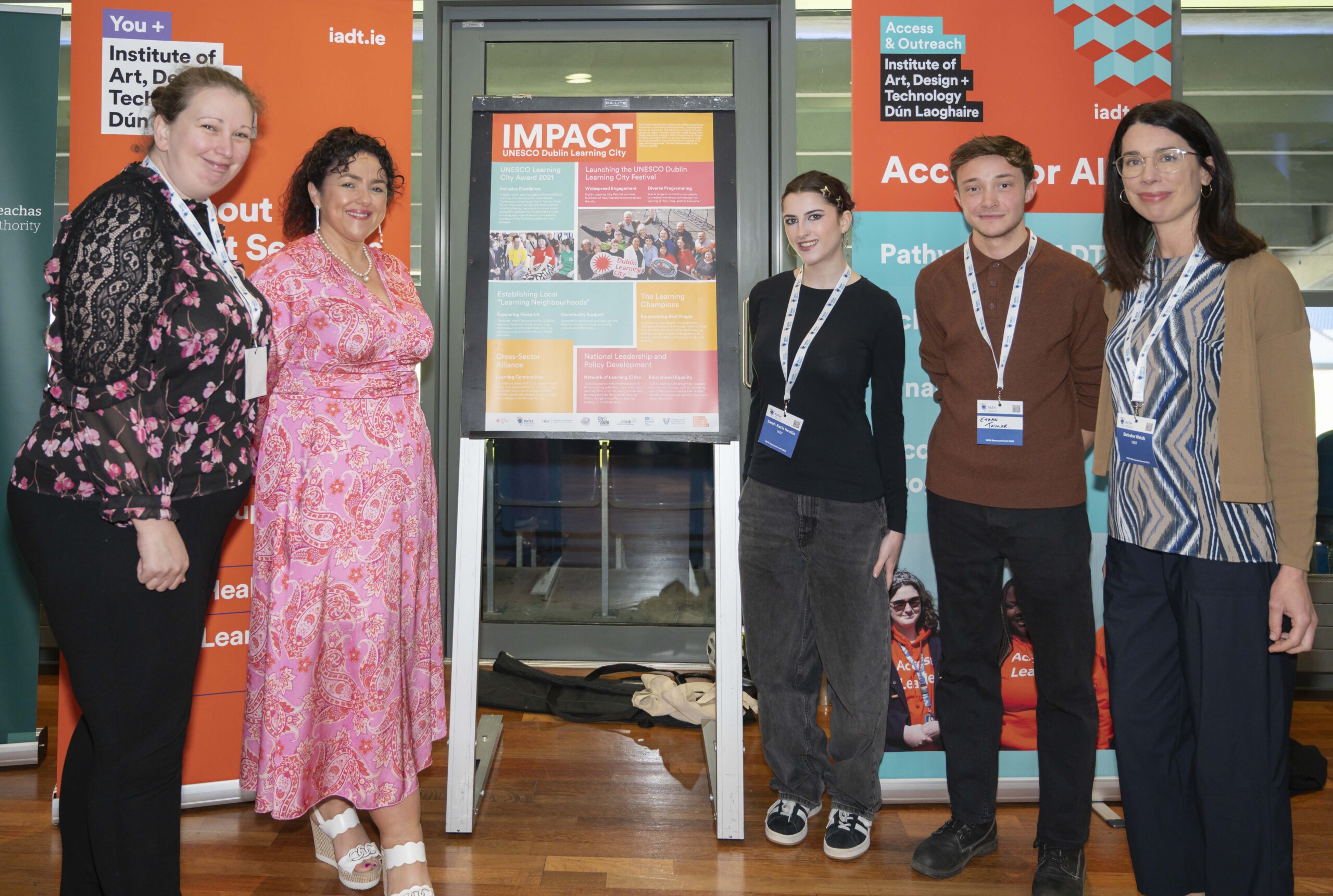 Group of participants standing beside a poster at PATH Showcase Event 2026